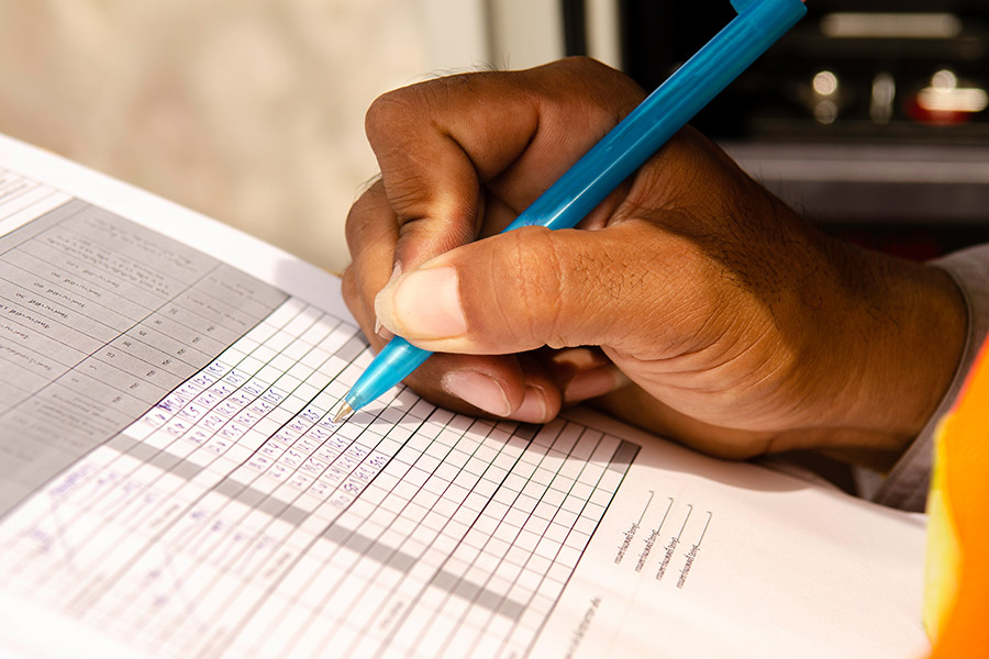 close-up of technician fill the maintenance form,Engineer write